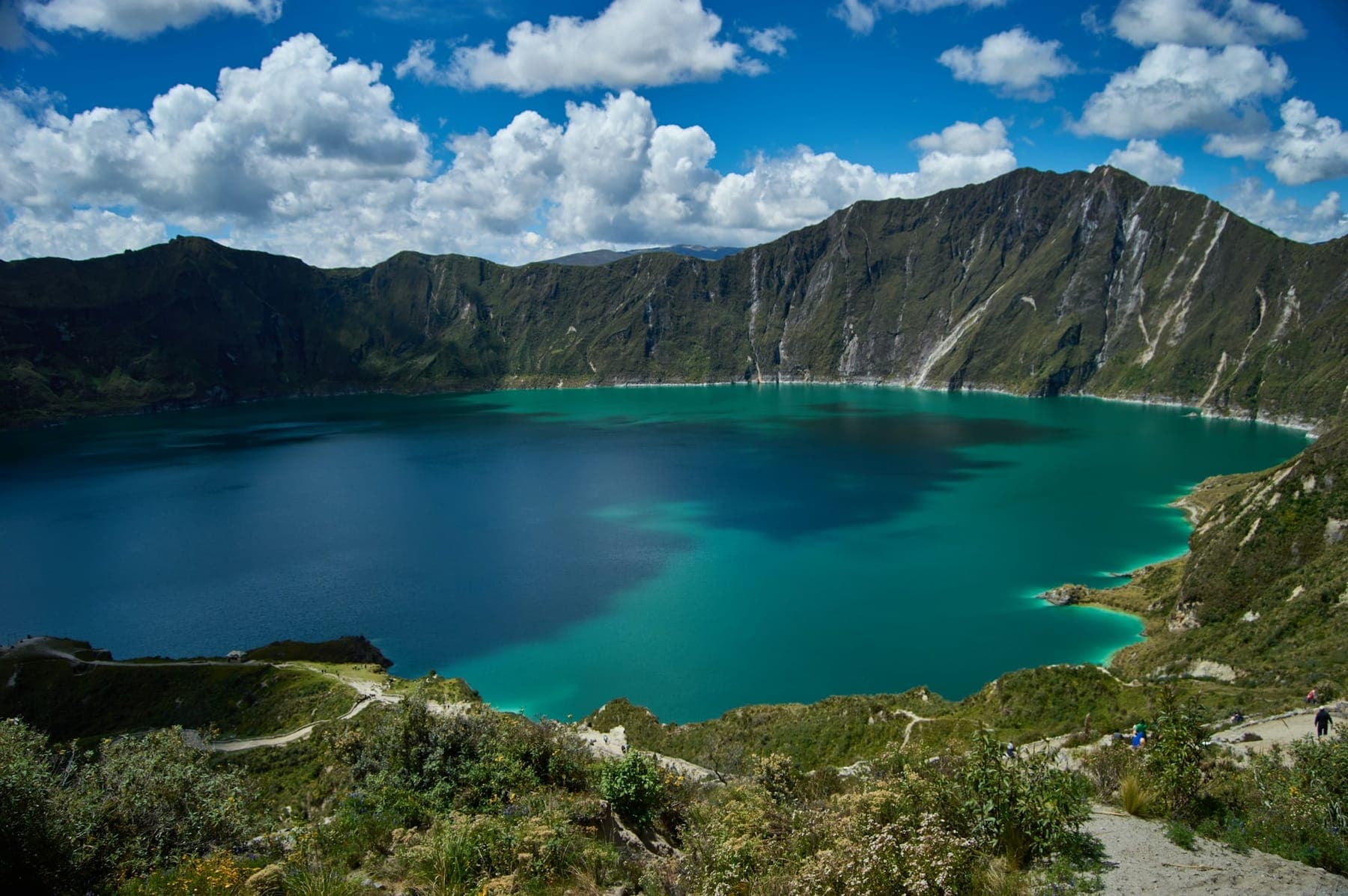 The turquoise crater lake of Quilotoa ringed by steep volcanic walls