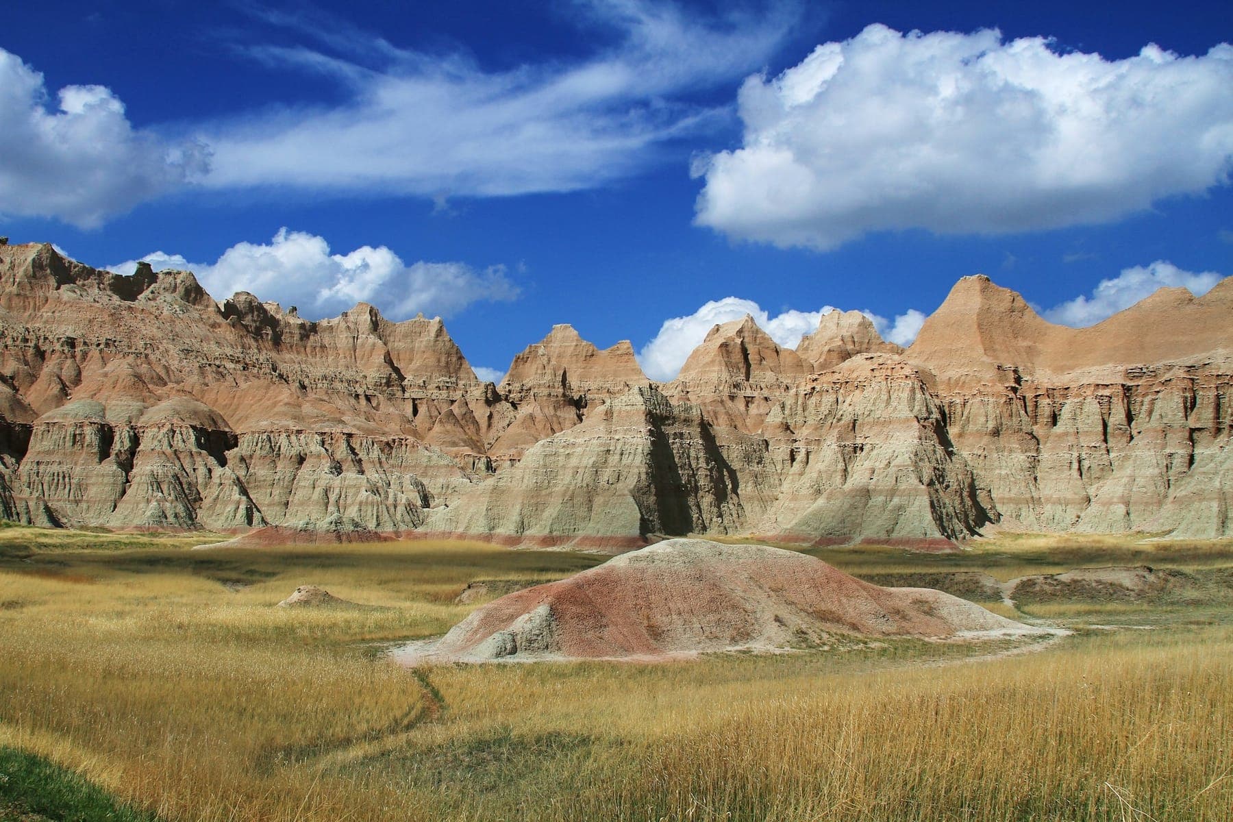 Striped rock formations of Badlands National Park under a clear sky