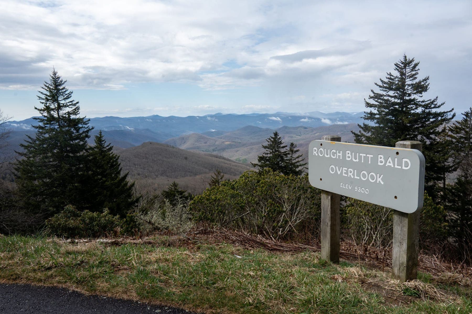 Layered blue ridges fading into the distance from the Rough Butt Bald Overlook on the Parkway