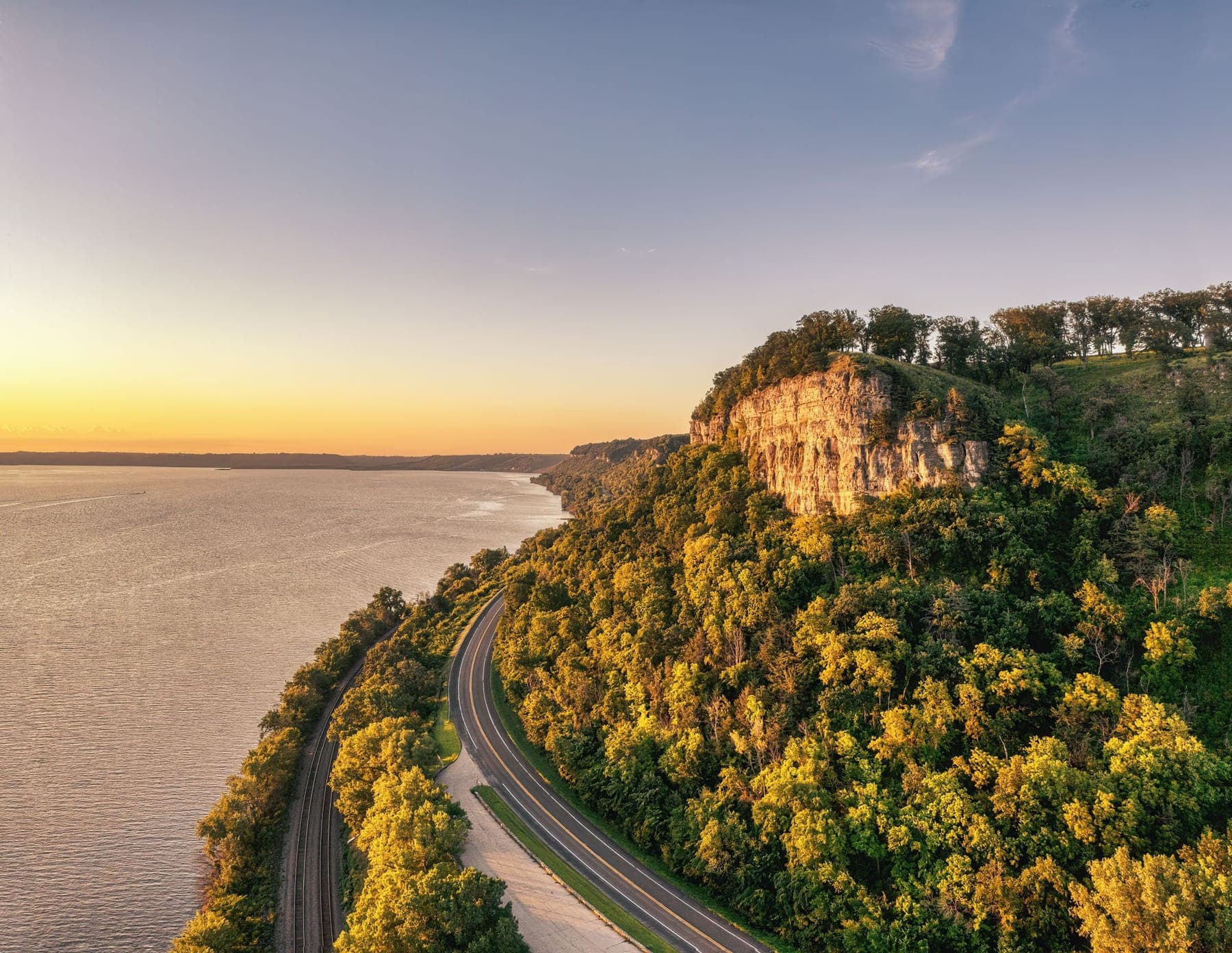 Golden-hour light on the river bluffs and highway at Stockholm, Wisconsin
